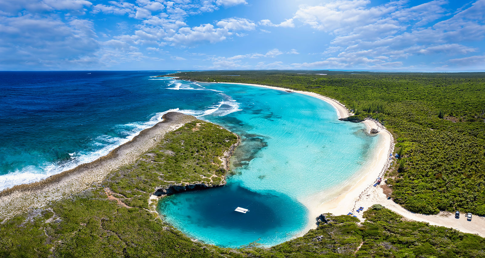 Indigo-House_exuma-12_1600 Aerial view of the Exuma Cays with winding sandbars, vibrant blue water, and lush green islands.